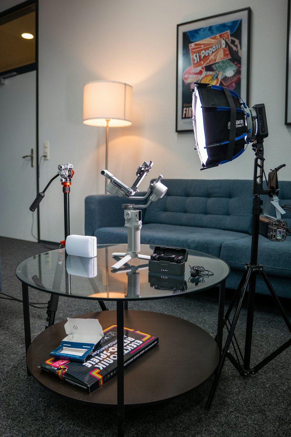 Studio equipment arranged around a coffee table for content creation.